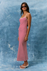 woman wearing a red and white striped spaghetti strap maxi dress and sunglasses