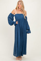 woman wearing a blue lace maxi dress with off-the-shoulder sleeves and voluminous puffed sleeves