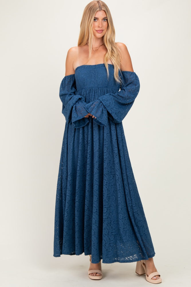woman wearing a strapless navy blue lace maxi dress with puff sleeves and a flowing skirt