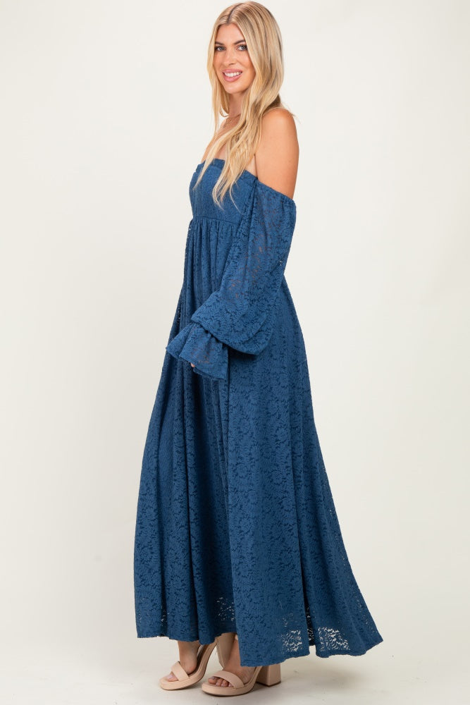 woman wearing a blue lace off-the-shoulder maxi dress with long sleeves and a flowing skirt