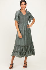 woman wearing a sage green pleated maxi dress with short flutter sleeves and ruffle details