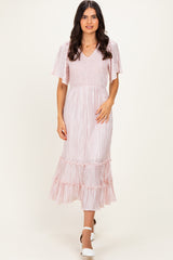 woman wearing a pink striped midi dress with flutter sleeves and a tiered ruffle hem