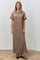 woman wearing a brown striped maxi dress with scalloped sleeves and a relaxed fit