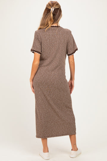 woman wearing a striped brown maternity maxi dress with short sleeves, showing her back and light shoes