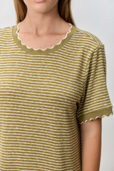 woman wearing a green and white striped t-shirt with scalloped neckline and sleeves