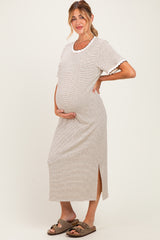 woman wearing a cream and brown striped maternity dress with short sleeves and a side slit, showing off her baby bump