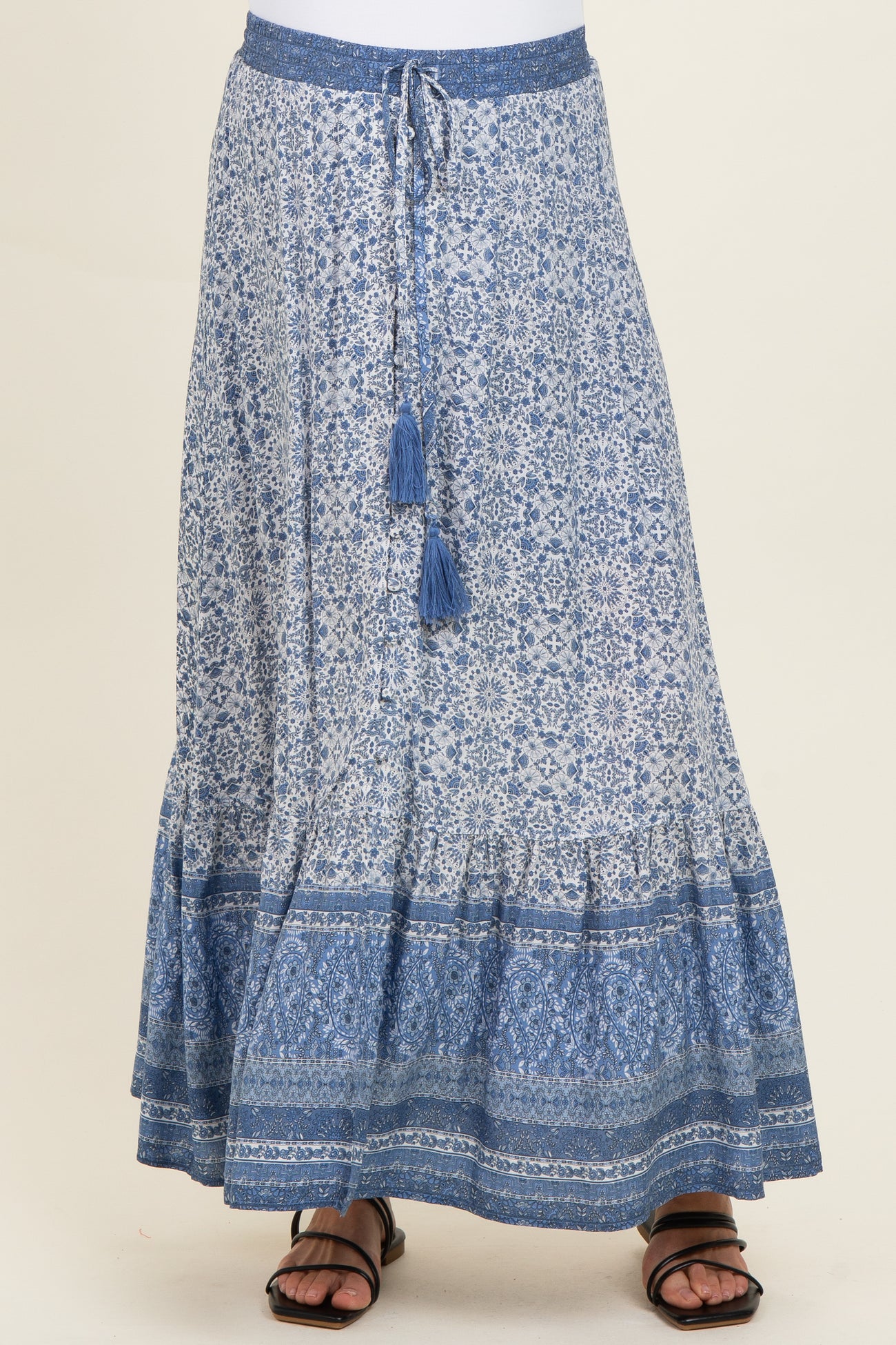maternity wear maxi skirt in blue with intricate patterns and a tied waistband, model wearing sandals