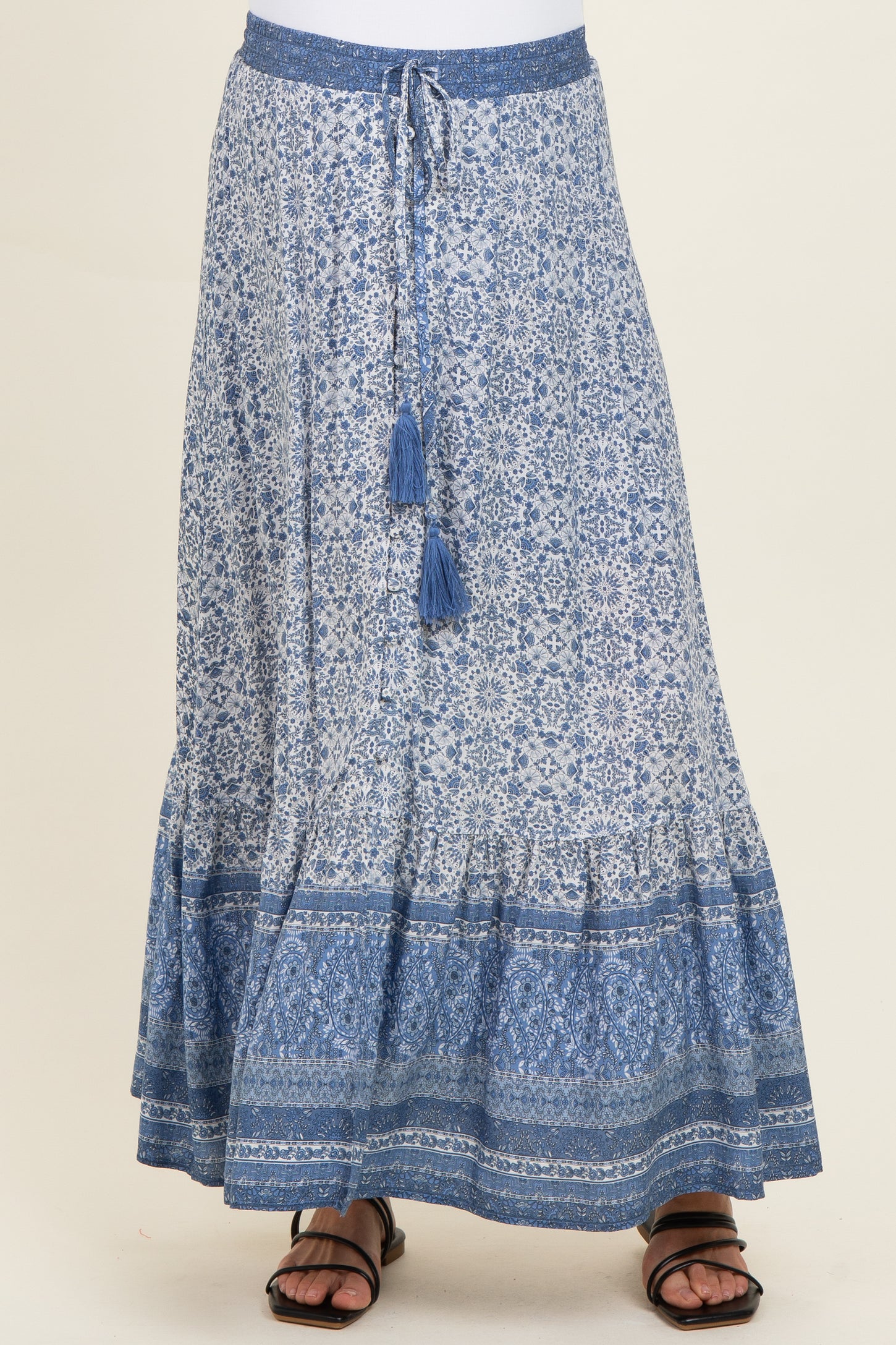 maternity wear maxi skirt in blue with intricate patterns and a tied waistband, model wearing sandals