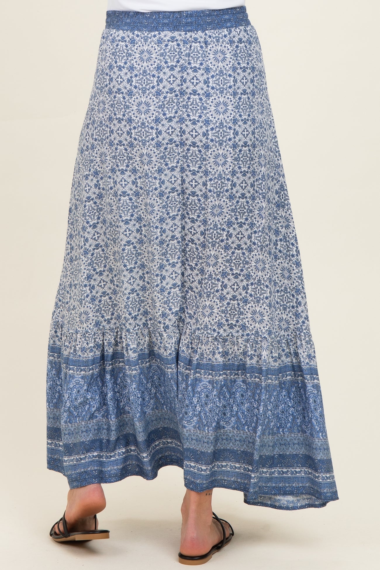 maternity wear blue patterned maxi skirt with a tiered hem, model seen from the back