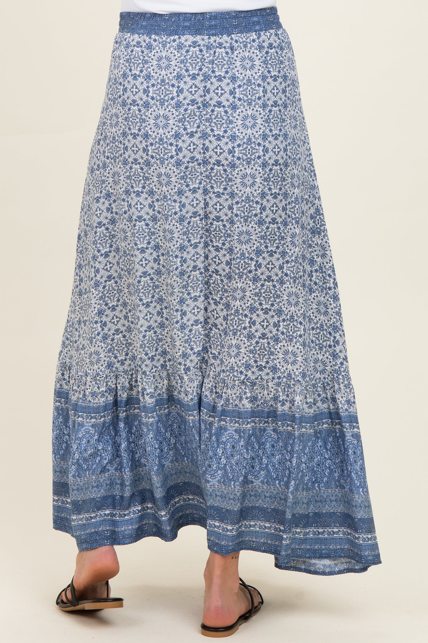 maternity wear blue patterned maxi skirt with a tiered hem, model seen from the back