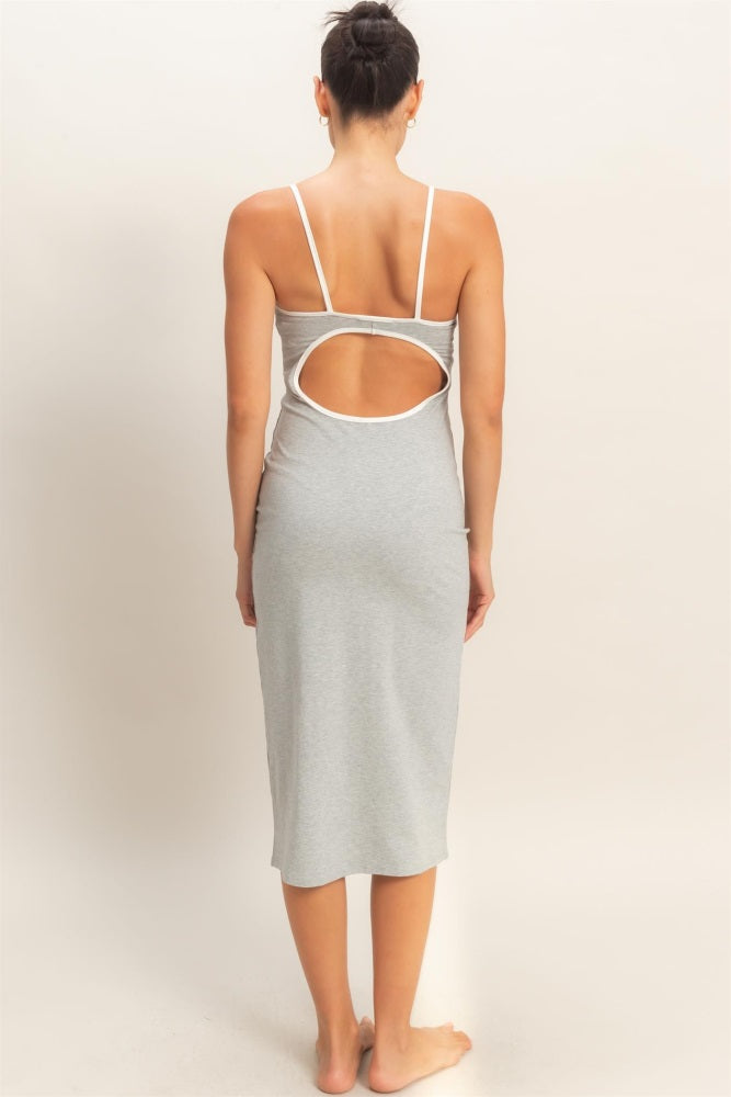 woman wearing a gray sleeveless dress with a unique back cutout detail