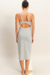woman wearing a gray sleeveless dress with a unique back cutout detail