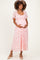 woman wearing a pink floral maternity dress with short flutter sleeves and a baby bump visible
