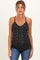 woman wearing a black floral print maternity tank top and showing her baby bump