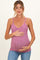 woman wearing a pink maternity tank top with a floral print and holding her baby bump