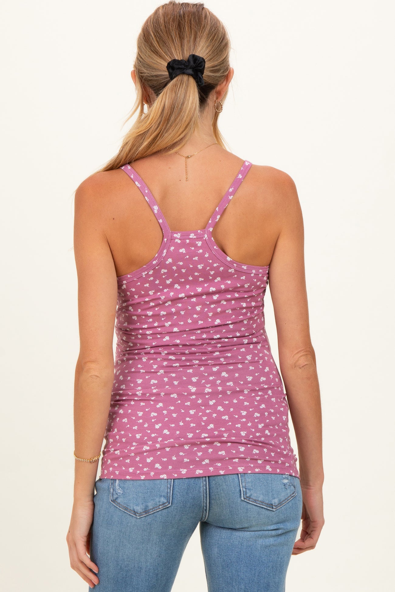 woman wearing a pink patterned maternity tank top with a fitted style and adjustable straps