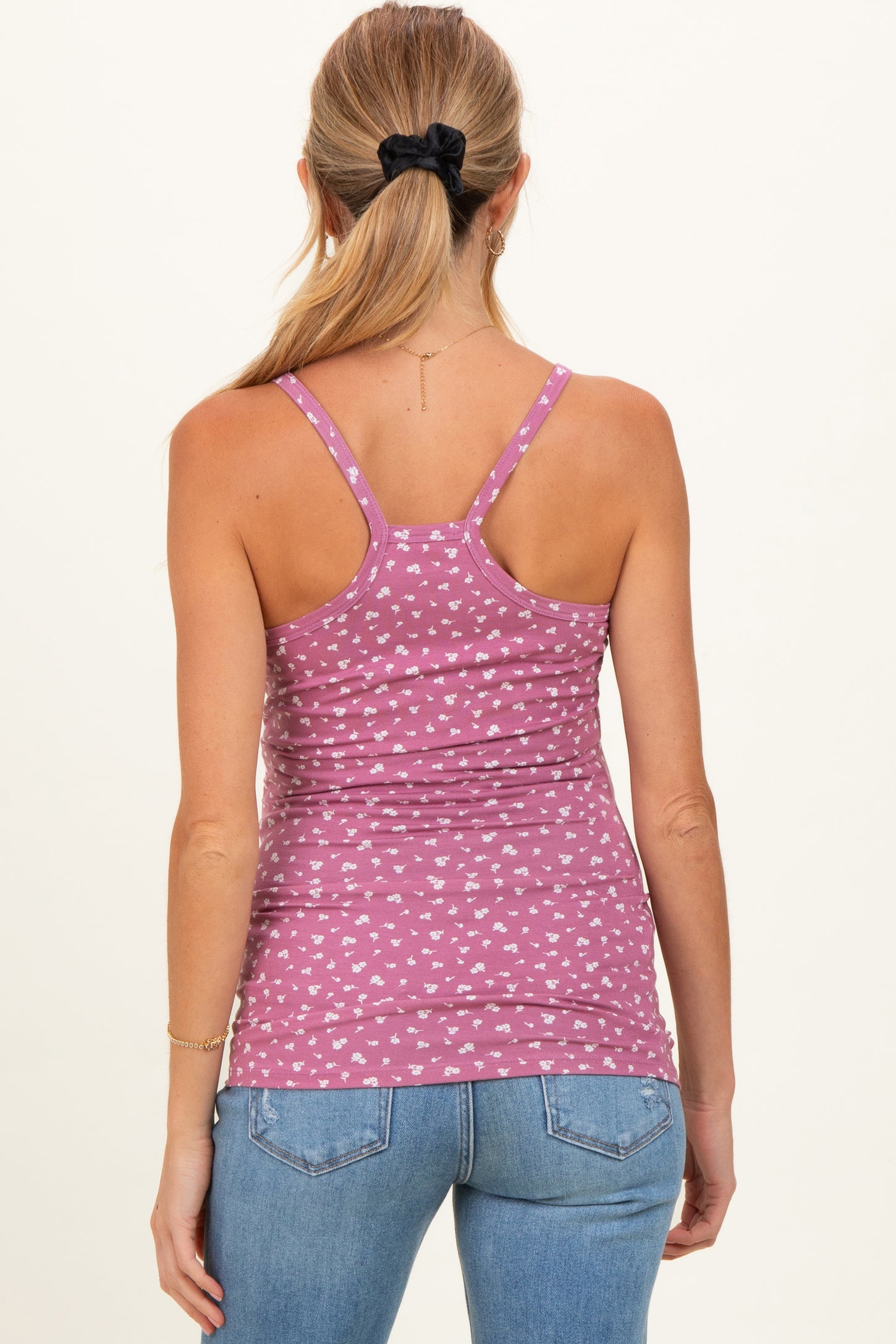 woman wearing a pink patterned maternity tank top with a fitted style and adjustable straps