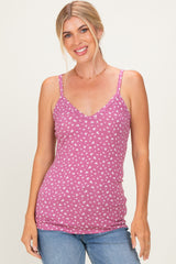 woman wearing a pink floral print spaghetti strap tank top with a v-neck and slim fit, paired with blue jeans