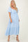 woman wearing a light blue maxi dress with flutter sleeves and a cinched waist detail