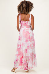woman wearing a pink and white tie-dye maternity maxi dress with a smocked back and adjustable straps