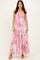 woman wearing a pink floral tiered maxi dress with a smocked bodice and spaghetti straps