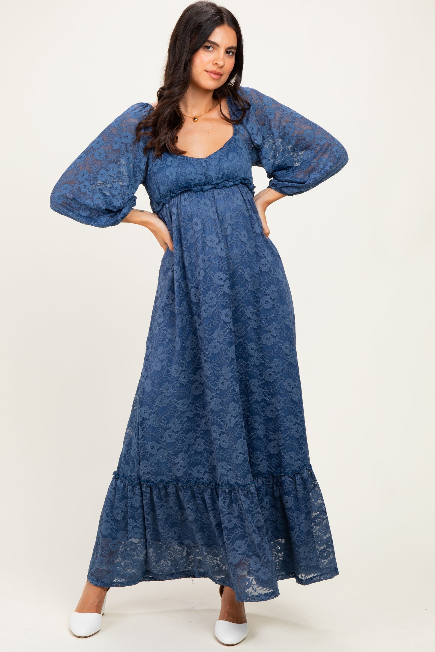 woman wearing a blue lace maxi dress with puff sleeves and a tiered skirt