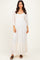 woman wearing a cream lace maxi dress with long sleeves and a tiered hemline