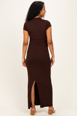 woman wearing a brown maternity maxi dress with a side slit, shown from the back