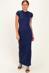 woman wearing a navy blue cap sleeve maxi dress with a fitted silhouette and side slit