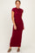 woman wearing a burgundy cap sleeve maxi dress, standing with a relaxed pose and smiling