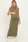 woman wearing a fitted olive green maternity maxi dress and holding her baby bump