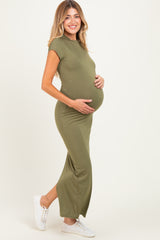 woman wearing a fitted olive green maternity maxi dress and holding her baby bump