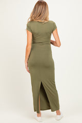woman wearing an olive green maternity maxi dress with a split at the back