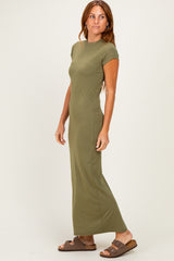 woman wearing an olive green short sleeve maxi dress and brown sandals