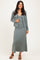 woman wearing a light green ribbed maxi dress with matching cardigan and strappy sandals