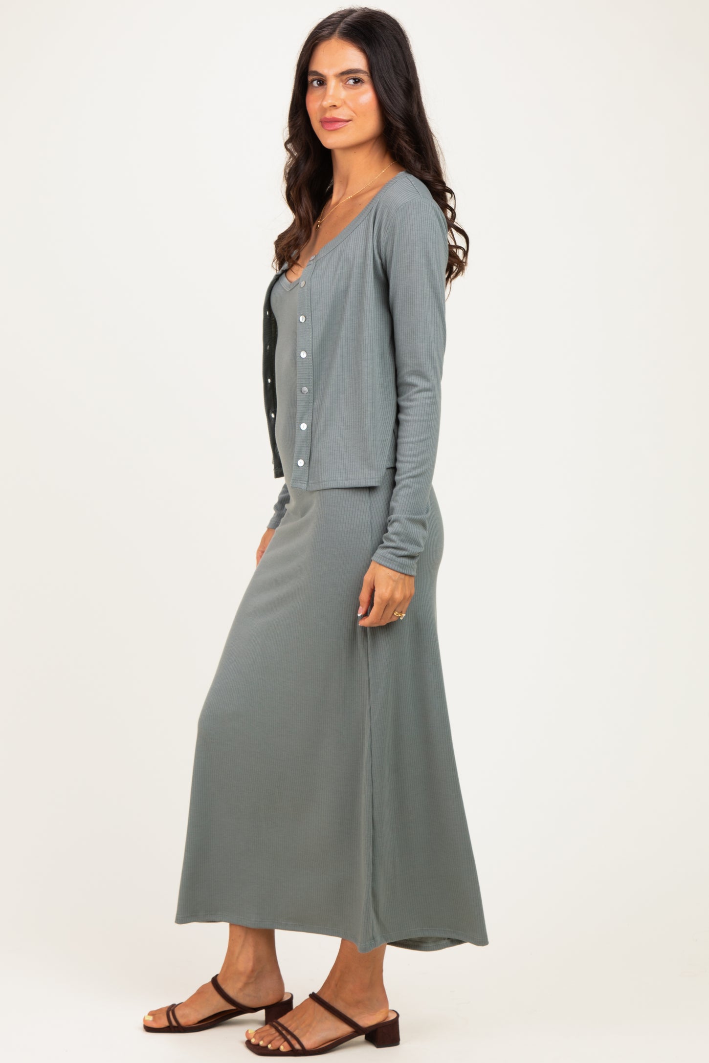 woman wearing a gray ribbed maxi dress with a matching cardigan and strappy sandals