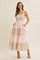 woman wearing a floral tiered maxi dress with pockets in pink and cream