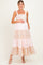 woman wearing a pink floral and striped maternity maxi dress and holding her baby bump