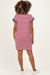 woman wearing a red and white striped maternity dress with navy blue accents, showing a stylish and comfortable back view