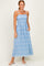 woman wearing a blue patterned maxi dress with spaghetti straps and pockets