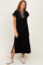 woman wearing a black cap sleeve midi dress with a striped collar and side slits