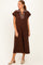 woman wearing a brown midi dress with a striped collar and short sleeves, standing against a white background