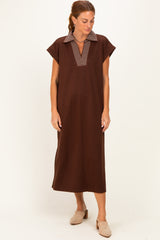 woman wearing a dark brown short sleeve dress with a striped collar and a relaxed fit