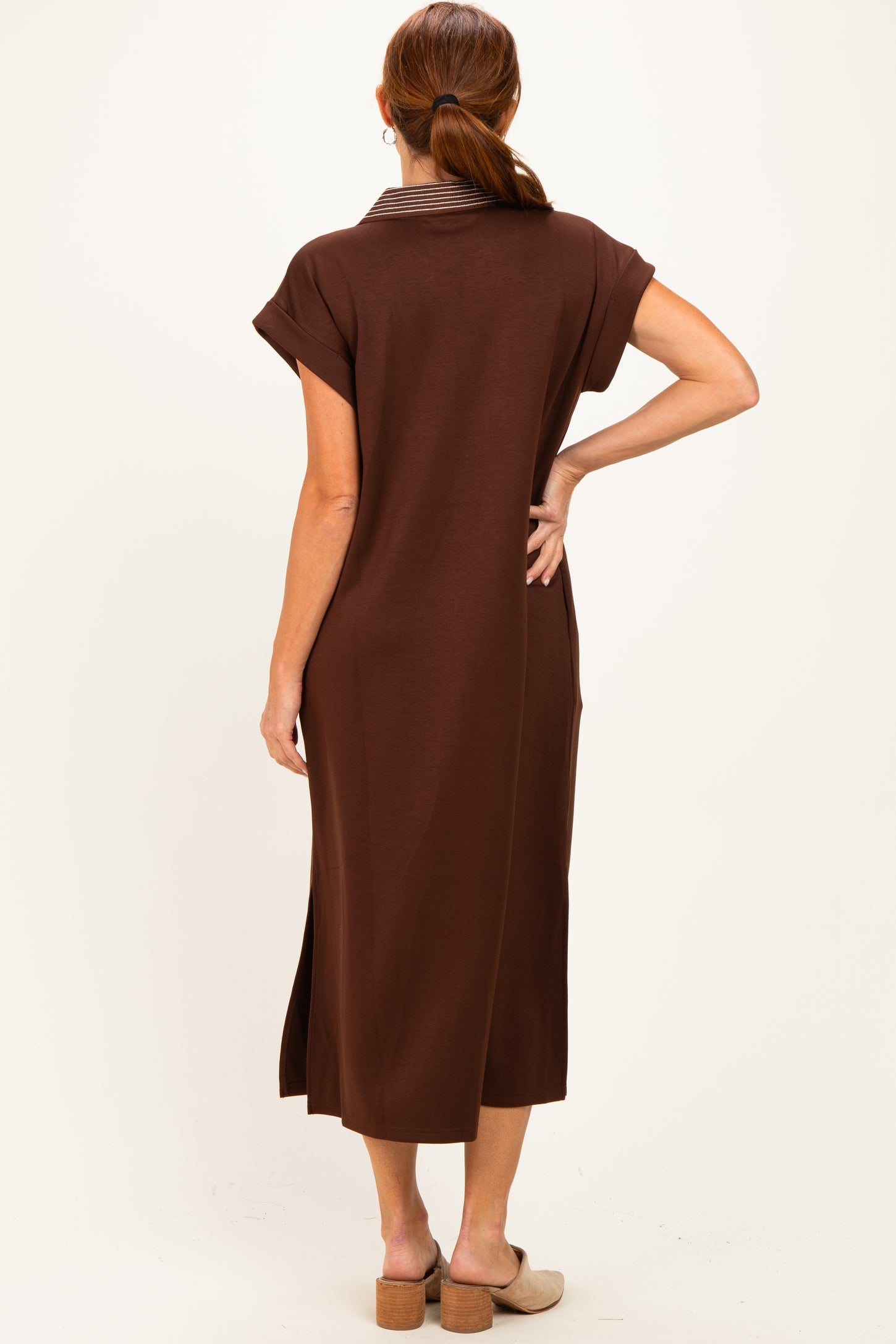 woman wearing a brown midi dress with short sleeves and a collar, shown from the back