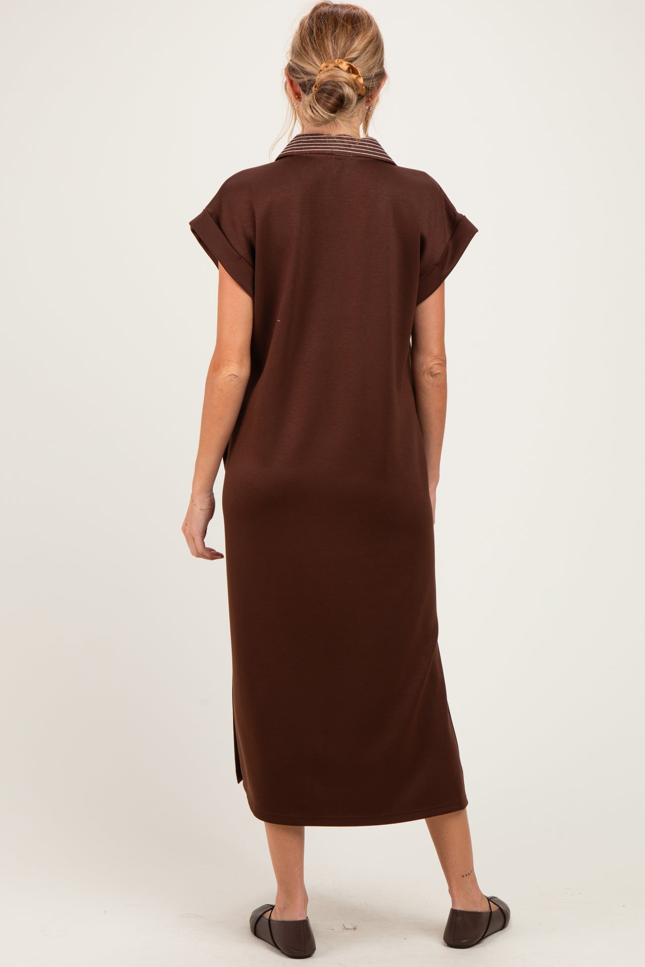 woman wearing a brown maternity dress with short sleeves and a collar, shown from the back