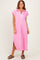 woman wearing a hot pink short sleeve midi dress with a collar and side slits