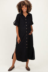 woman wearing a black button-up maternity dress with short sleeves and side slits, highlighting her baby bump