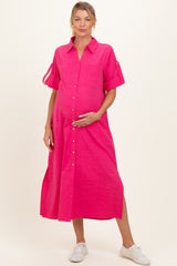 woman wearing a bright pink maternity shirt dress with short sleeves and holding her baby bump