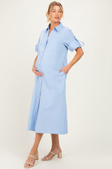 woman wearing a light blue maternity shirt dress with pockets and a visible baby bump