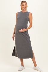 woman wearing a gray sleeveless maternity maxi dress with side slits and a visible baby bump